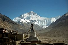 
We rounded a corner and stopped at the Rongbuk monastery (5032m). The Everest North Face glistened white in the afternoon sun from the Rongbuk Monastery with its umbrella and spire-topped chorten connected to the ground with flapping prayer flags.
